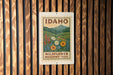 A sign for the Idaho Wildflower Meadows Trail is displayed on a wooden wall.