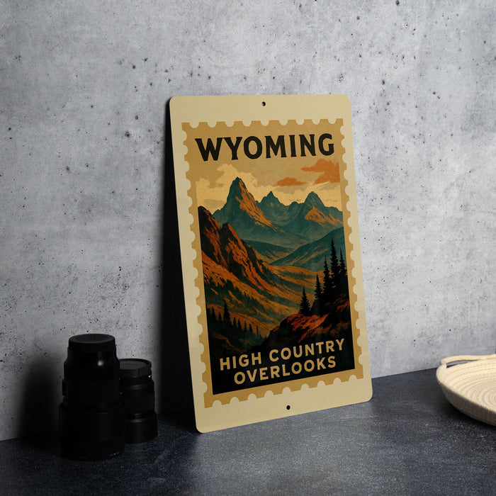 A vintage-style poster of the High Country overlooks of Wyoming, featuring a mountain landscape with pine trees and a sunset sky.