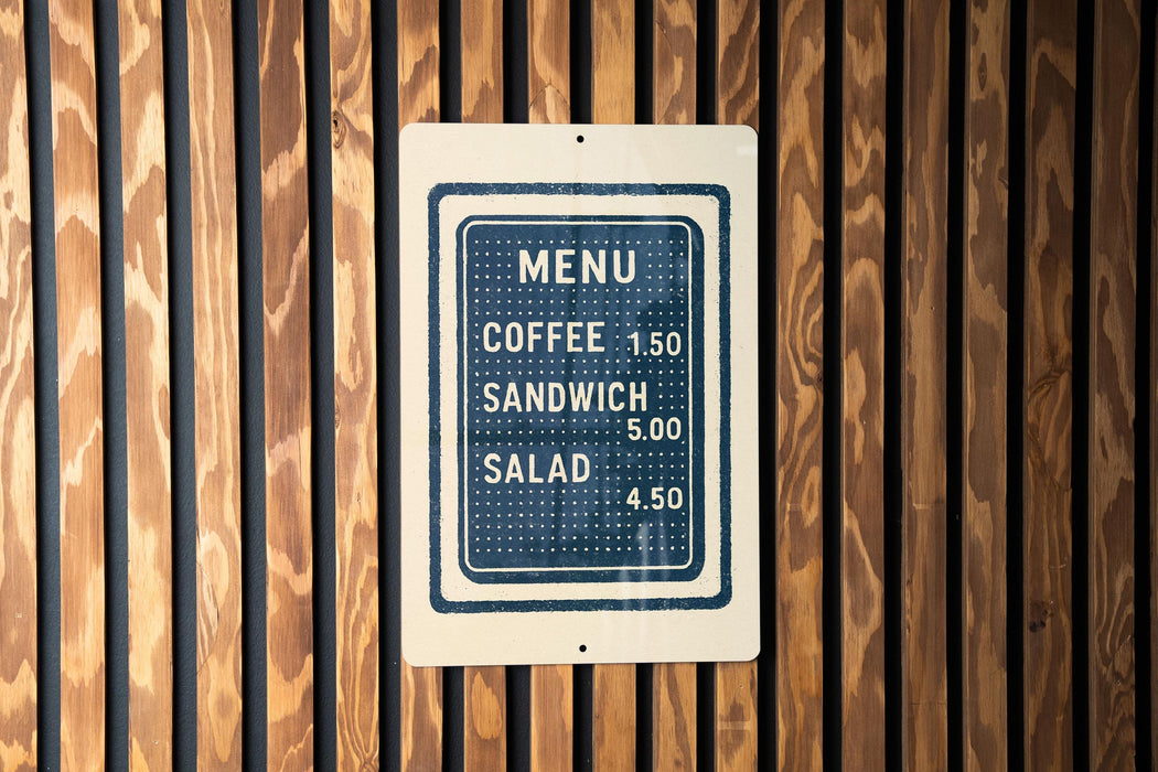 A menu sign is displayed on a wooden wall, providing information about the available food and drink items.