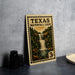 A metal sign with a waterfall illustration and the text "Texas Waterfall Loop" is displayed on a table.