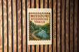 A sign for the Missouri River Bend Trail is displayed on a wooden wall.