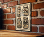 A metal sign with illustrations of four jars containing different items, such as a mushroom, a bat, a bird, and a bird's head, mounted on a brick wall.