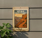 A sign for Utah Canyon Rim Drive, featuring a scenic illustration of the canyon landscape.