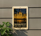 A vintage-style poster of the Hungarian Parliament Building, also known as the Hungarian Parliament, is displayed on a wall.