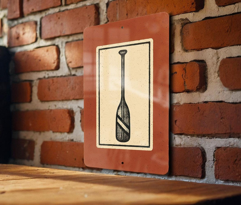 a sign with a paddle on it, mounted on a brick wall.
