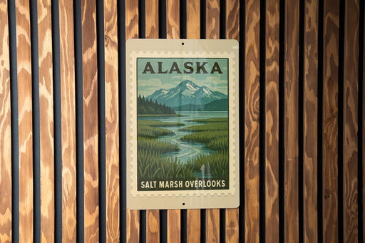 A metal sign with a scenic landscape of mountains, a river, and lush vegetation, mounted on a wooden wall.