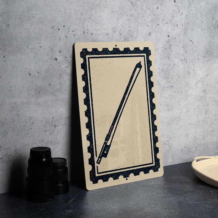 a framed print of a bowing bow on a wall, with a stack of black camera lenses and a woven basket placed next to it.
