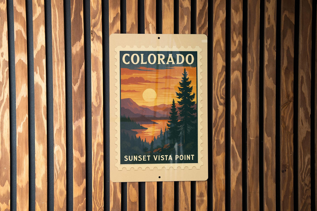 A vintage-style sign for the Sunset Vista Point in Colorado, featuring a scenic landscape with a sunset over a mountain range.
