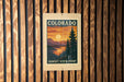 A vintage-style sign for the Sunset Vista Point in Colorado, featuring a scenic landscape with a sunset over a mountain range.