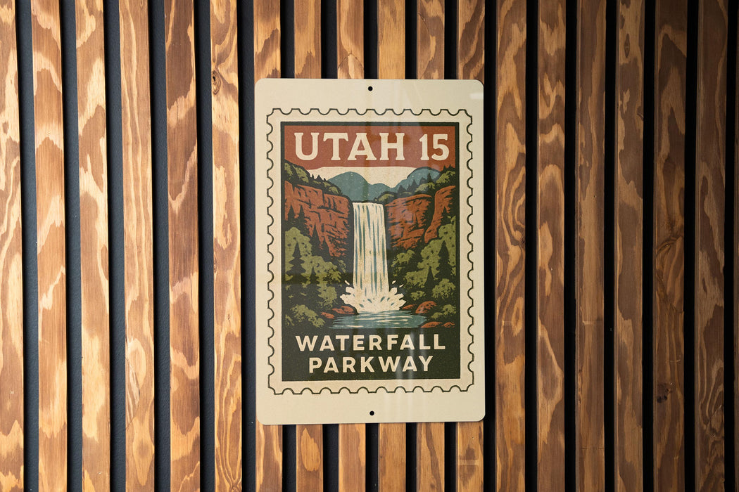 A metal sign with a waterfall and parkway printed on it, mounted on a wooden wall.