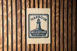 A sign with the text "HARBOUR MILESTONE 256 METRES" is displayed on a wooden wall.