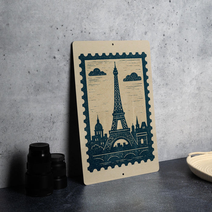 A framed print of the Eiffel Tower is displayed on a gray wall, accompanied by a stack of black camera lenses and a woven basket.