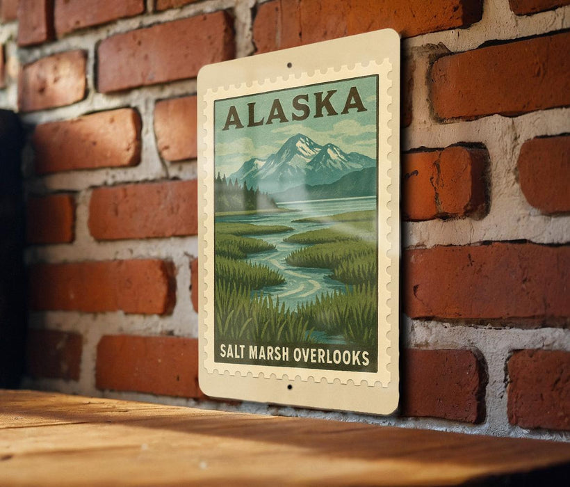 A framed poster of a scenic landscape with mountains and a river is hanging on a brick wall.