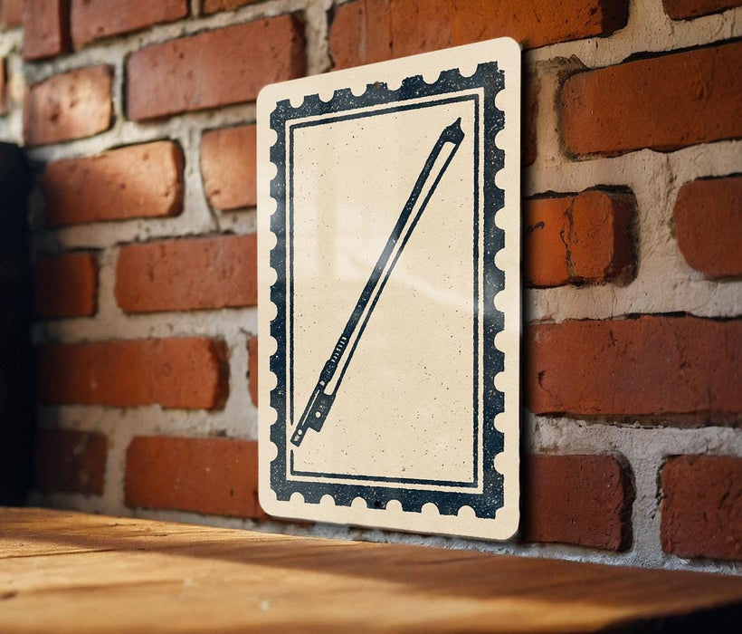 A black and white illustration of a bow and arrow is displayed on a wooden surface against a brick wall.