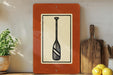 a wooden shelf with various kitchen items, including a paddle, a cutting board, and some lemons.