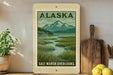 A framed poster of a scenic landscape with mountains and a river, depicting the Salt Marsh Overlooks in Alaska.