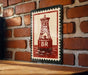 A red and white metal sign with a lighthouse image is mounted on a brick wall.
