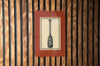 a sign with a paddle on it, mounted on a wooden wall.