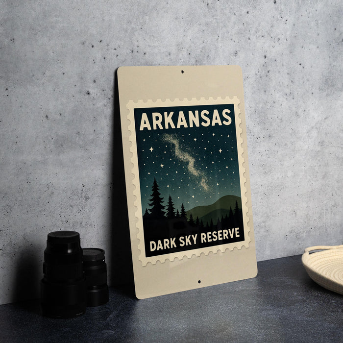 A framed poster of a night sky with stars and silhouetted trees, displaying the text "ARKANSAS DARK SKY RESERVE".