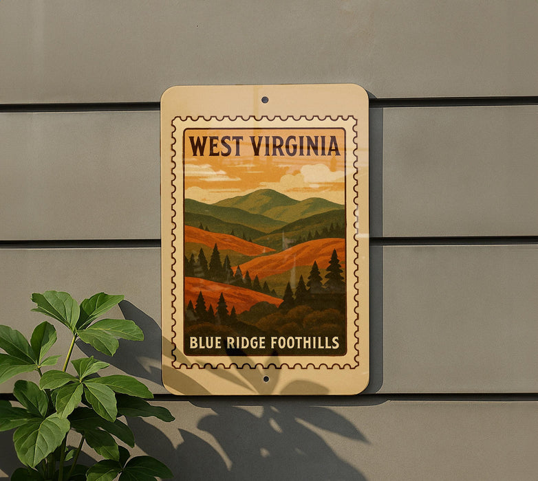 A sign for West Virginia featuring a mountain landscape with pine trees and a warm, orange sky.