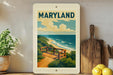 A framed poster of a scenic beach view in Maryland, featuring a wooden bench overlooking the ocean.