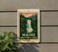 A sign for Maine Waterfall Loop, featuring a scenic illustration of a waterfall surrounded by pine trees and mountains.