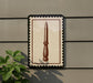 a decorative sign with a knife depicted on it, mounted on a wall.