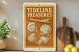 a sign with the text "TIDELINE TREASURES" and illustrations of various seashells.
