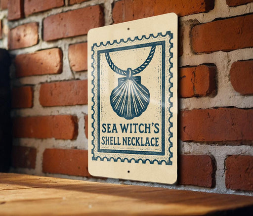 A sign with a seashell and a rope is mounted on a brick wall.