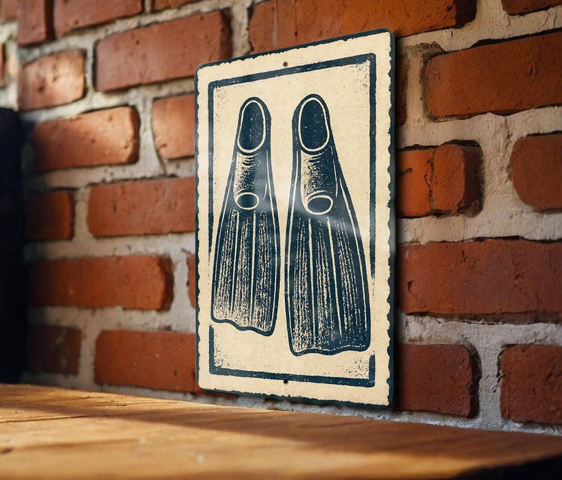 a sign with a pair of flippers on it, mounted on a brick wall.