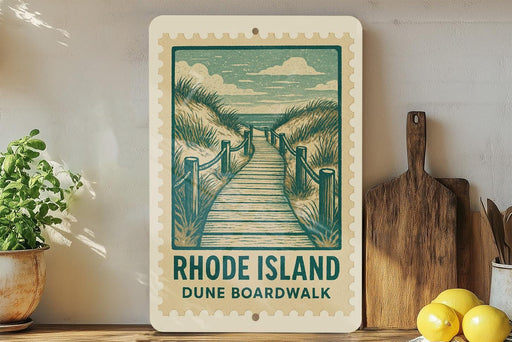 A framed illustration of a wooden boardwalk leading to a beach, with the text "RHODE ISLAND DUNE BOARDWALK" on the frame.