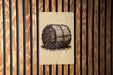 a sign with a black and white illustration of a hay bale on a wooden wall.