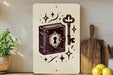 a white sign with a black illustration of a book and a key, surrounded by stars and other decorative elements.