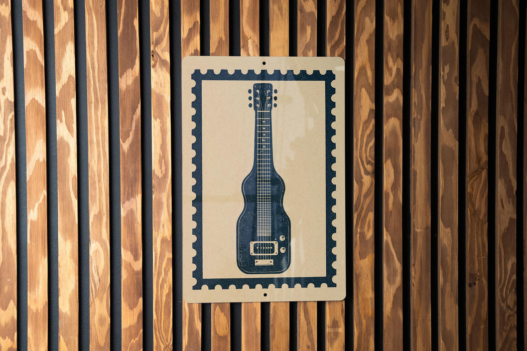A framed image of a guitar is displayed on a wooden wall.
