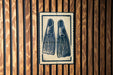 A sign with a pair of flippers on it is displayed on a wooden wall.