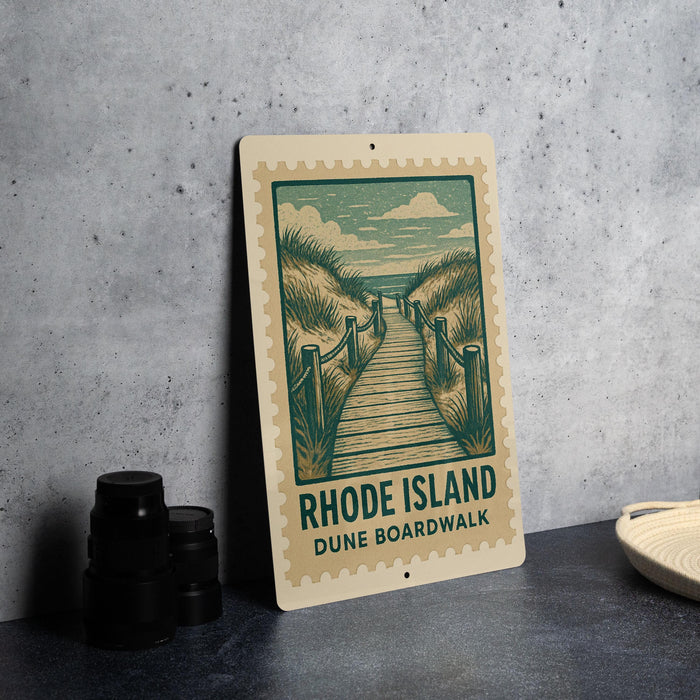 A sign for the Rhode Island Dune Boardwalk, featuring a wooden walkway leading to the beach.