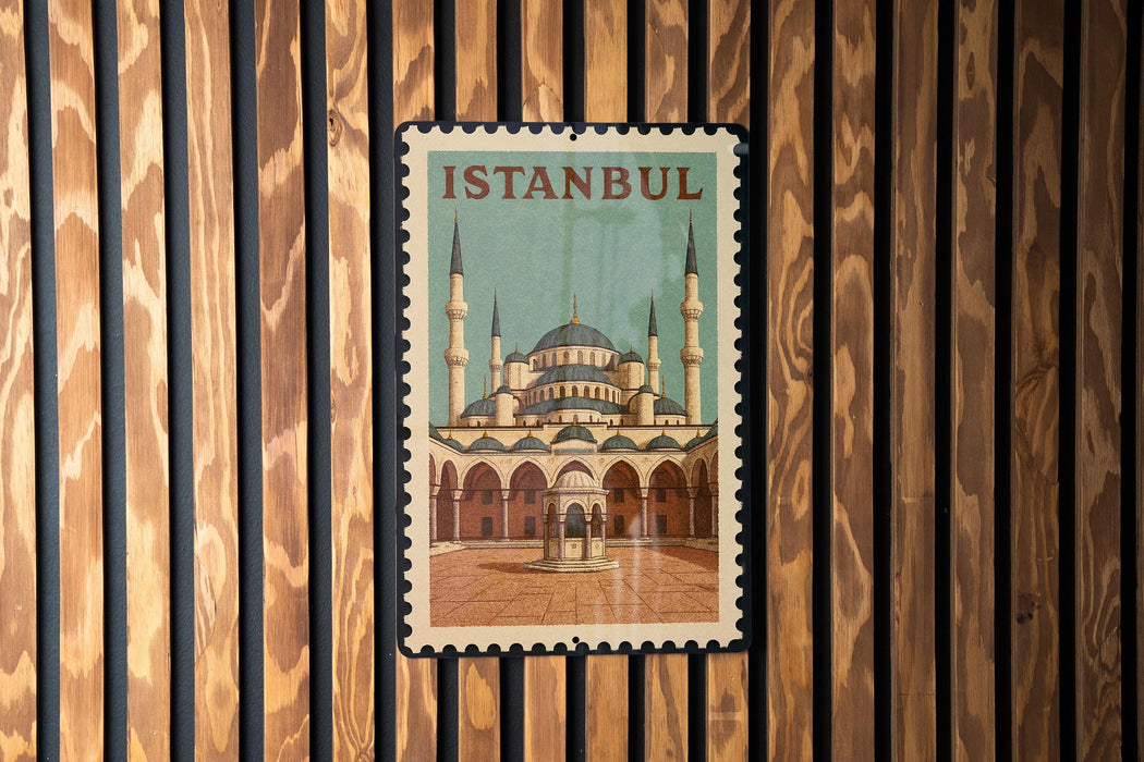 A framed poster of the Blue Mosque, a famous landmark in Istanbul, Turkey, is displayed on a wooden wall.