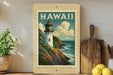 A framed vintage-style poster of a lighthouse on a cliff, with the word "HAWAII" prominently displayed, is displayed on a shelf next to a wooden cutting board and some lemons.