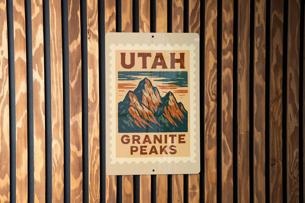 A sign for the Utah Granite Peaks, featuring a mountain illustration, is displayed on a wooden wall.