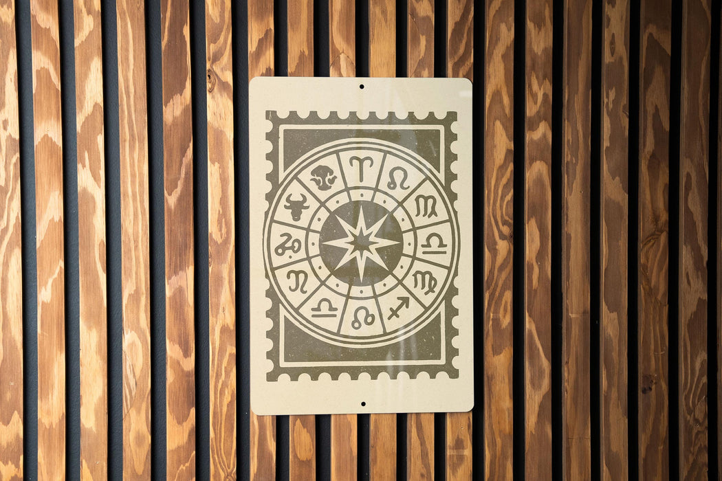 a wooden wall with a metal sign displaying a zodiac wheel.