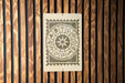 a wooden wall with a metal sign displaying a zodiac wheel.
