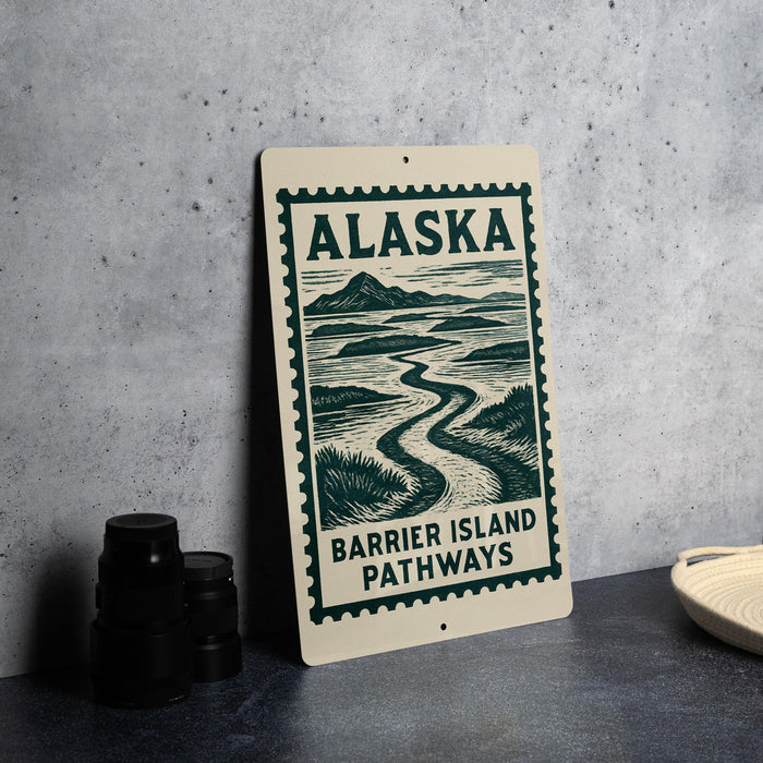 A sign for Alaska's Barrier Island Pathways is displayed on a table, with a stack of black camera lenses and a woven basket nearby.