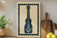 a framed illustration of a guitar on a shelf, with a potted plant to the left and a wooden cutting board to the right.