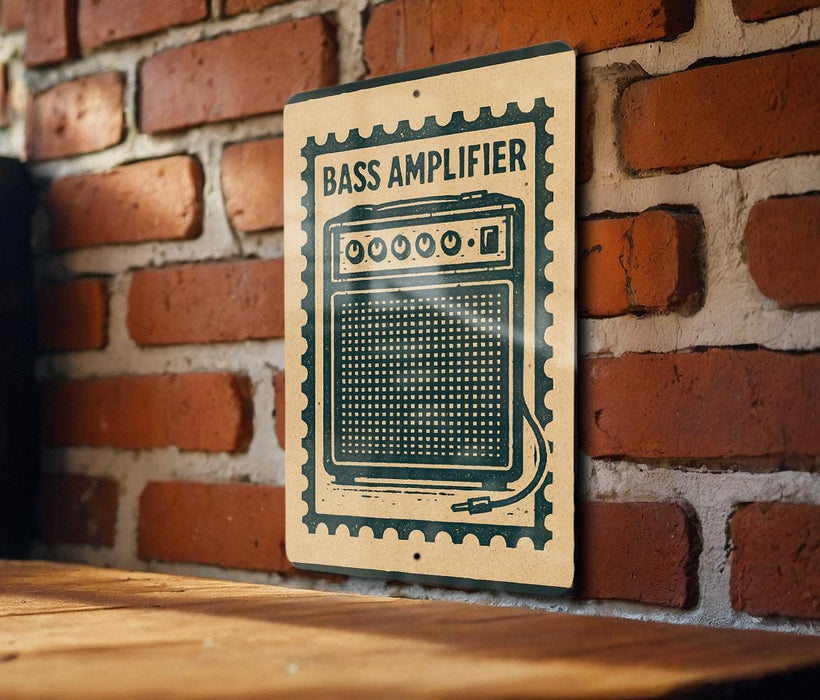 A sign with the word "BASS AMPLIFIER" printed on it is mounted on a brick wall.