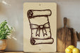 a wooden cutting board with a scroll-like design on it, placed on a shelf next to a potted plant and some lemons.