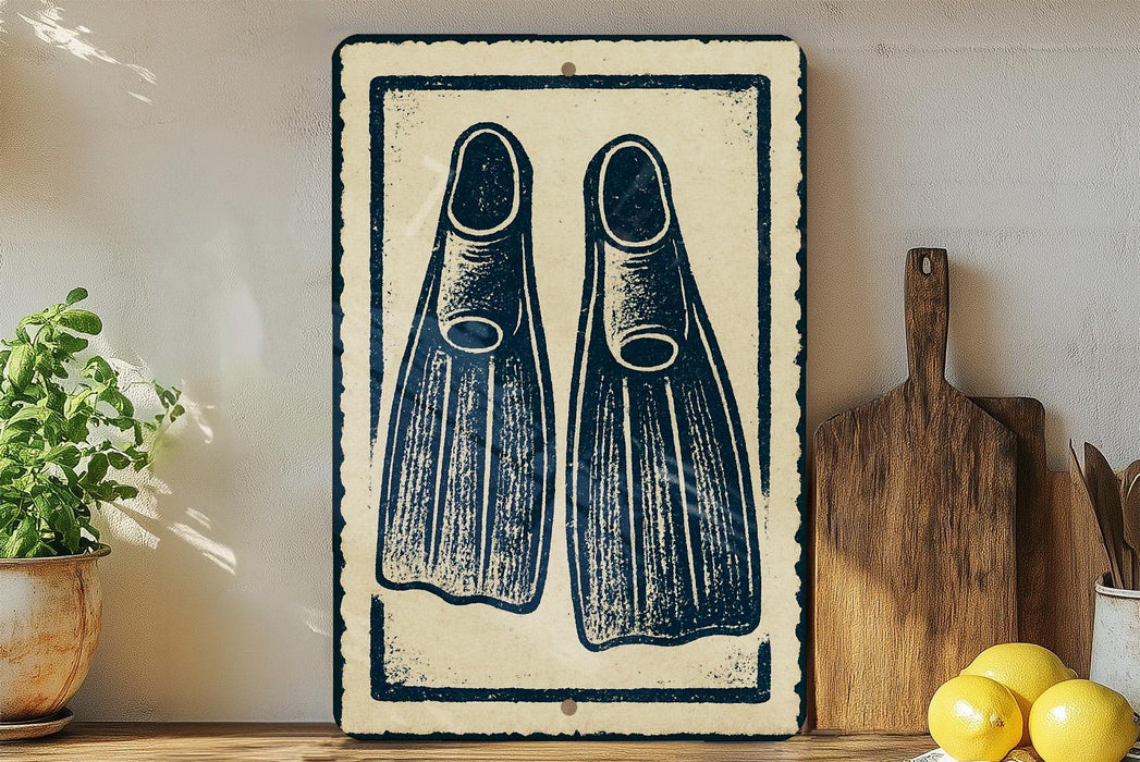 a framed artwork of two blue and white fins, placed on a shelf next to a wooden cutting board and a potted plant.