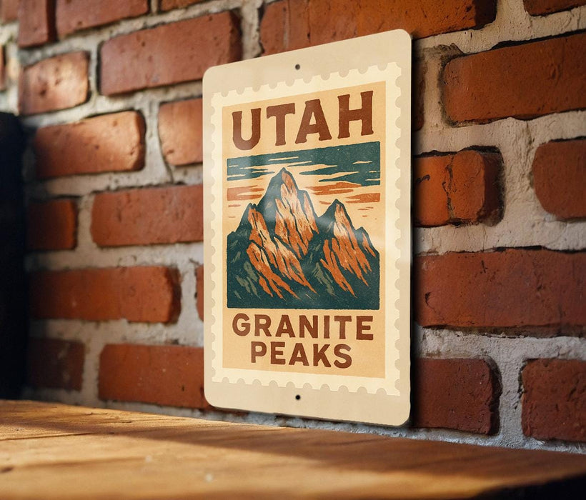 A metal sign with the text "UTAH GRAINITE PEAKS" is displayed on a brick wall.