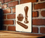a sign with a vintage-style illustration of a seal, wax, and a stamp, mounted on a brick wall.