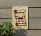 a sign with a scroll and a ribbon, mounted on a wall.
