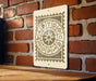 a sign with astrological symbols on it, mounted on a brick wall.
